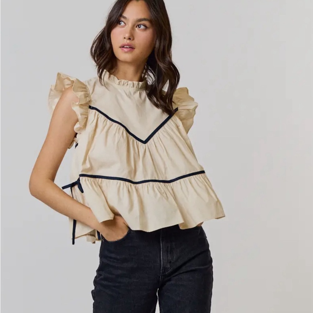 Ruffled high neck, contrast, side tie detail in  contrasting blue